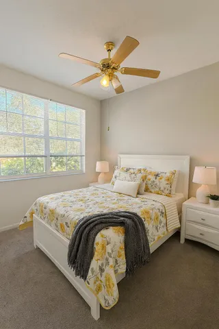 a bedroom with bed and a window