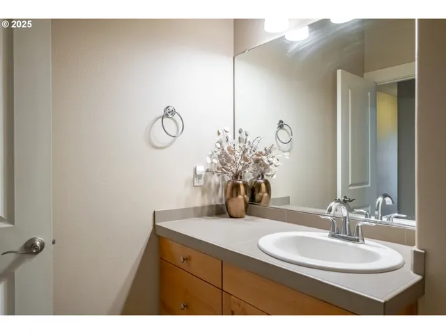 a bathroom with a sink vanity and a mirror