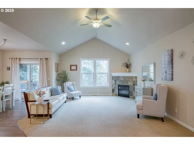 a living room with furniture a fireplace and a chandelier