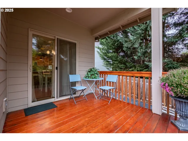 a balcony with chairs and wooden floor