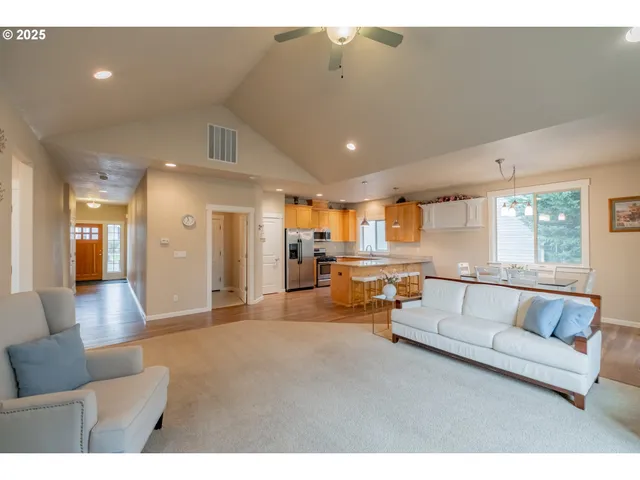 a living room with furniture and kitchen view
