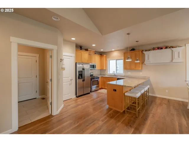 a kitchen with stainless steel appliances refrigerator stove microwave and cabinets