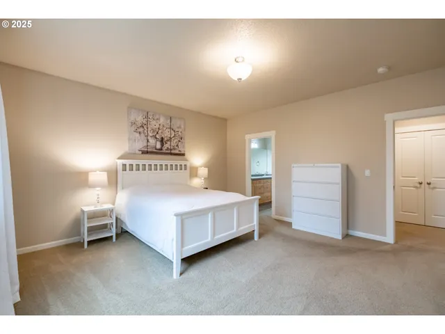 a bedroom with a bed and a night stand