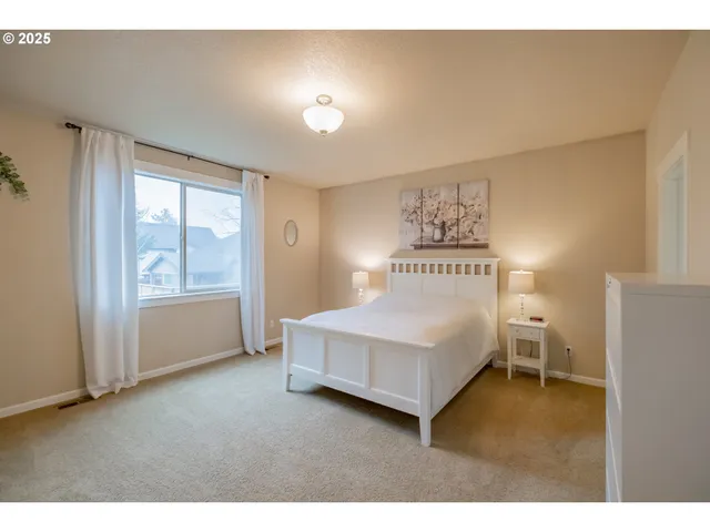 a spacious bedroom with a bed and a window