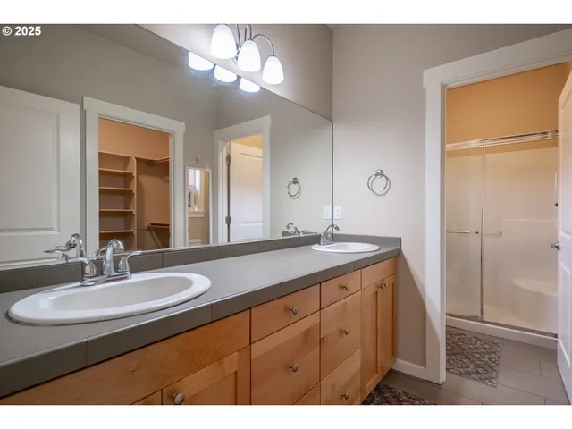 a bathroom with a sink double vanity and a mirror