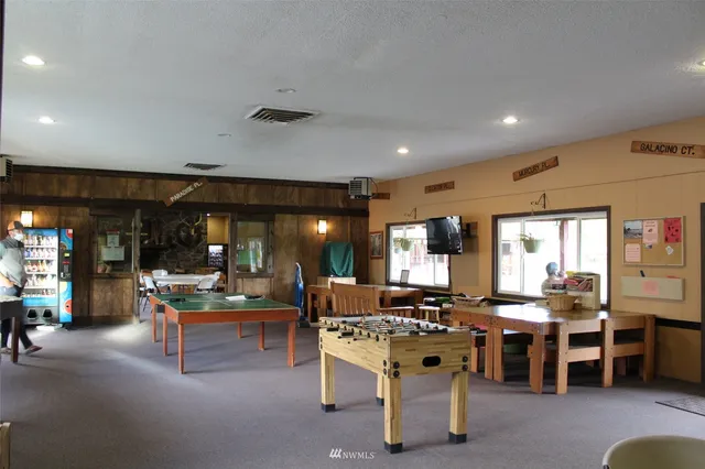 a view of a swimming pool with outdoor seating