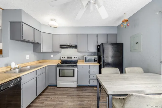 a kitchen with a sink a refrigerator and a stove