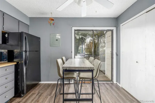 a dining room with furniture a chandelier and wooden floor