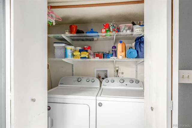 a utility room with dryer washer and shoe rack