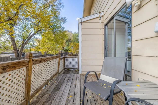 a view of balcony with wooden floor and outdoor seating