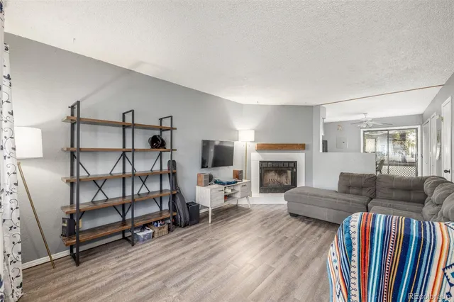a living room with furniture a fireplace and a flat screen tv