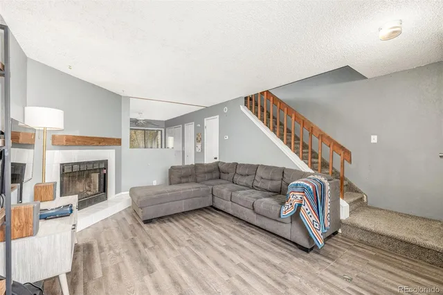 a living room with furniture and a fireplace