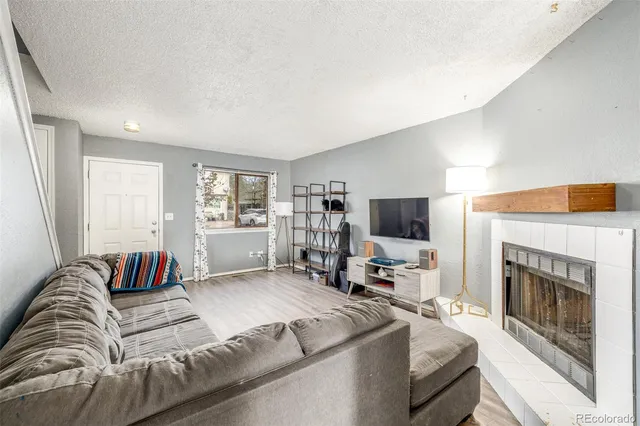 a living room with furniture fireplace and flat screen tv