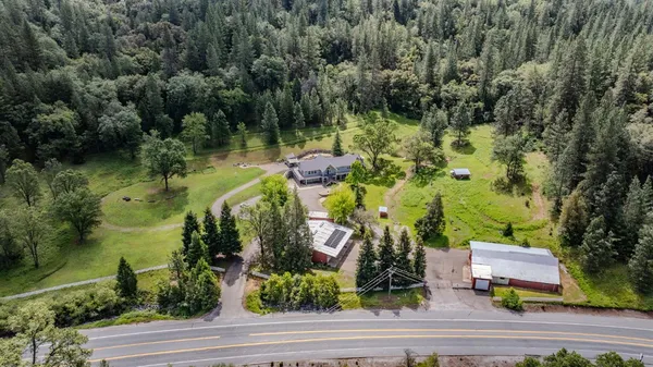 an aerial view of a house with a yard basket ball court and outdoor seating