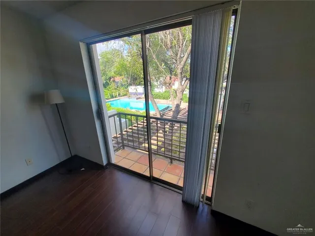 a view of a porch with wooden floor and doors