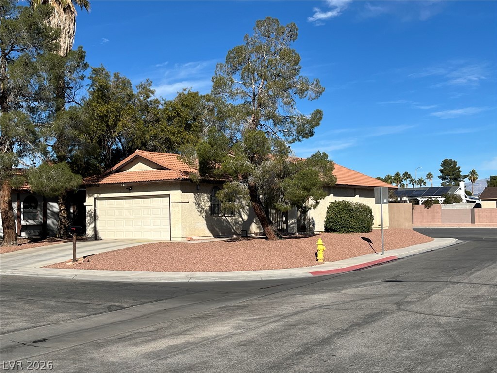 6412 West Pearcrest Road Las Vegas, NV 89108 - Photo 1 of 17 A well-maintained facade with a prominent garage and verdant landscaping.