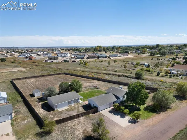 an aerial view of a house with a garden