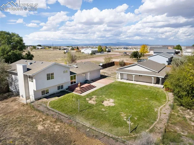 an aerial view of residential houses with yard