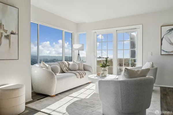 a bedroom with a bed and large windows