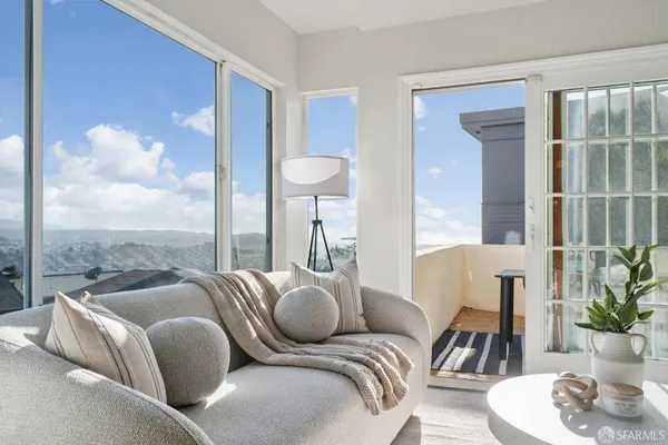a bedroom with a bed couch and a window