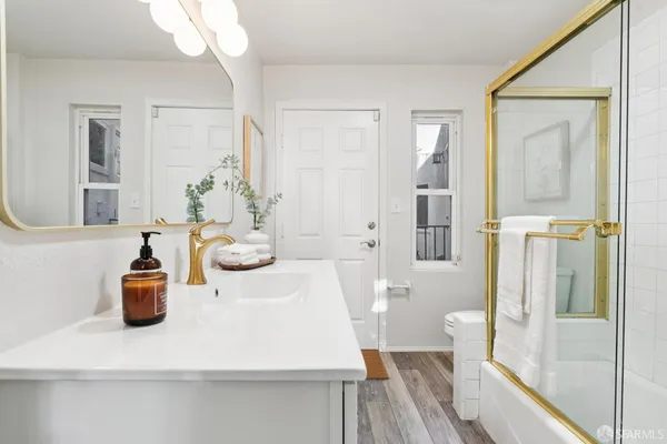 a bathroom with a toilet sink and mirror