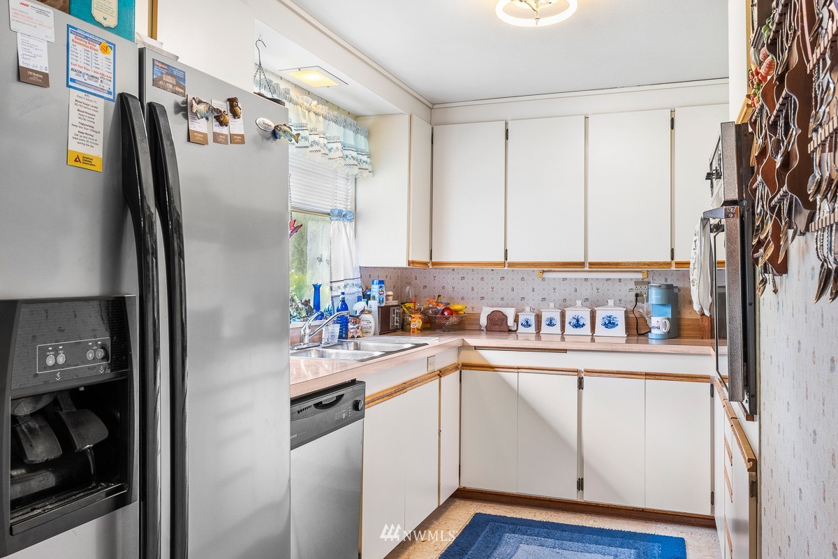 15053 Southeast 113th Street Renton, WA 98059 - Photo 15 of 31 a kitchen with stainless steel appliances a sink and a refrigerator
