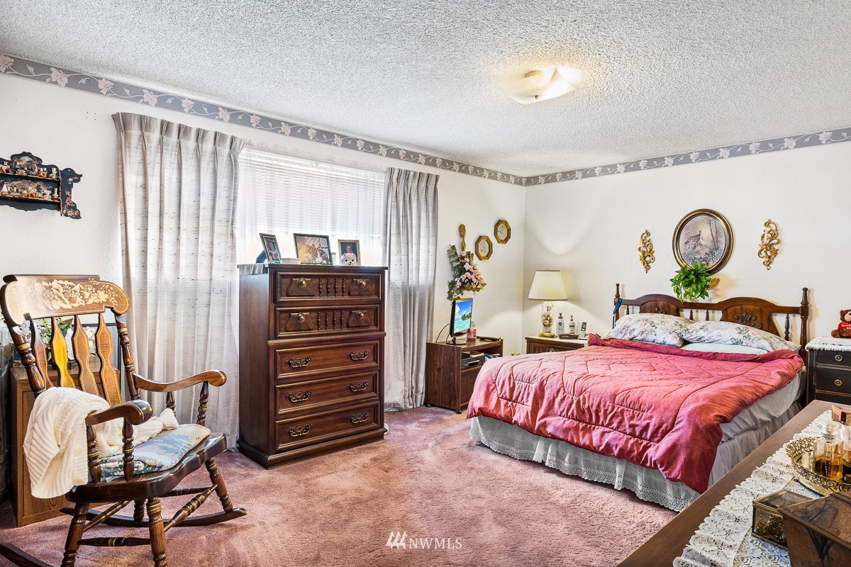 15053 Southeast 113th Street Renton, WA 98059 - Photo 17 of 31 a bedroom with a bed and furniture