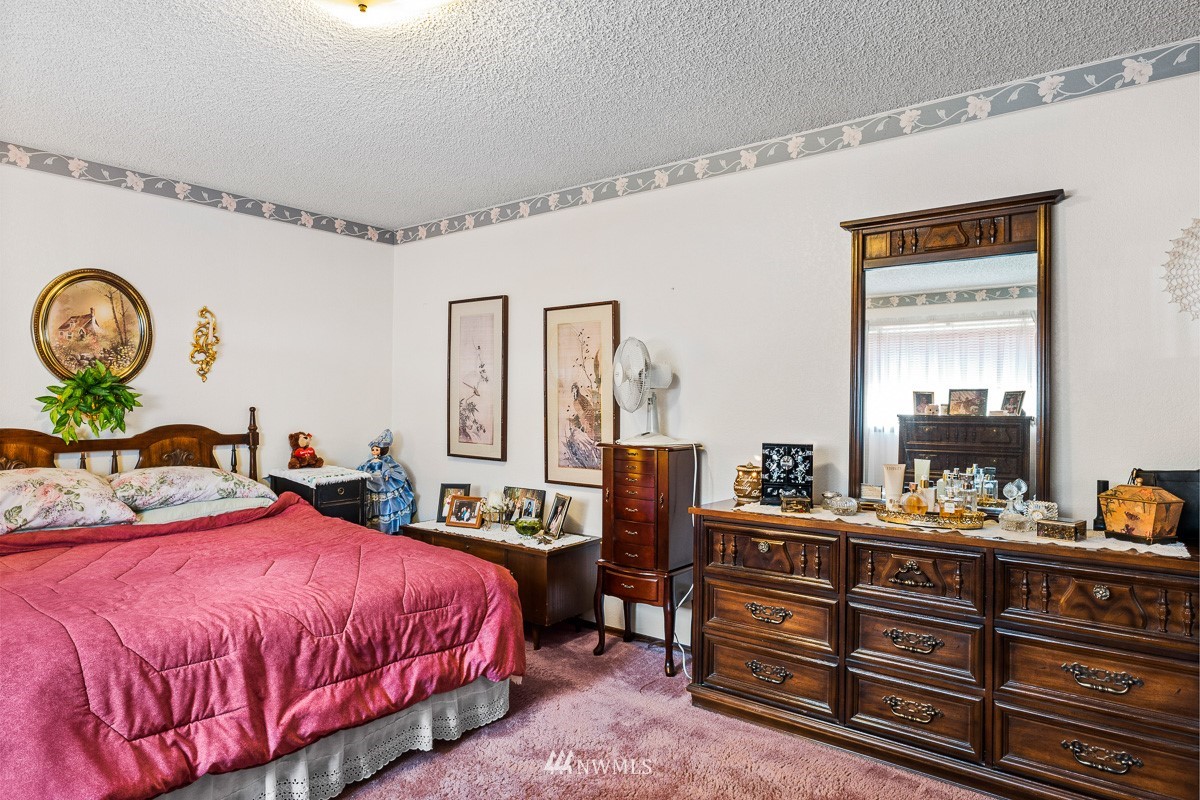 15053 Southeast 113th Street Renton, WA 98059 - Photo 18 of 31 a bedroom with a bed and a dresser