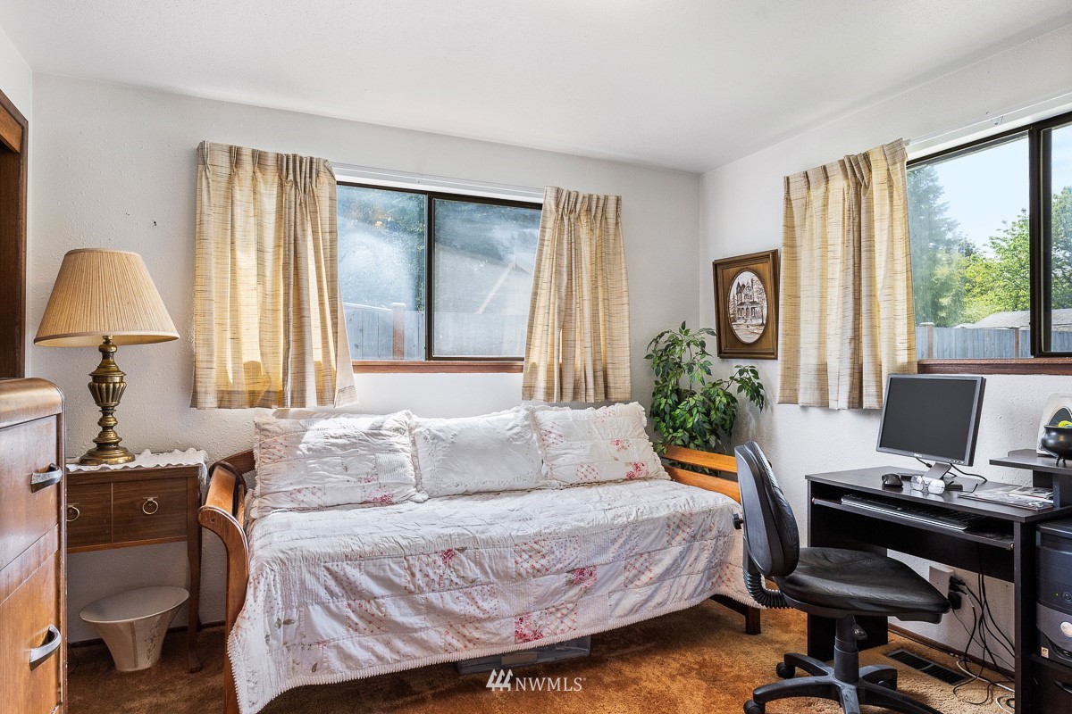 15053 Southeast 113th Street Renton, WA 98059 - Photo 21 of 31 a bedroom with a bed and large windows