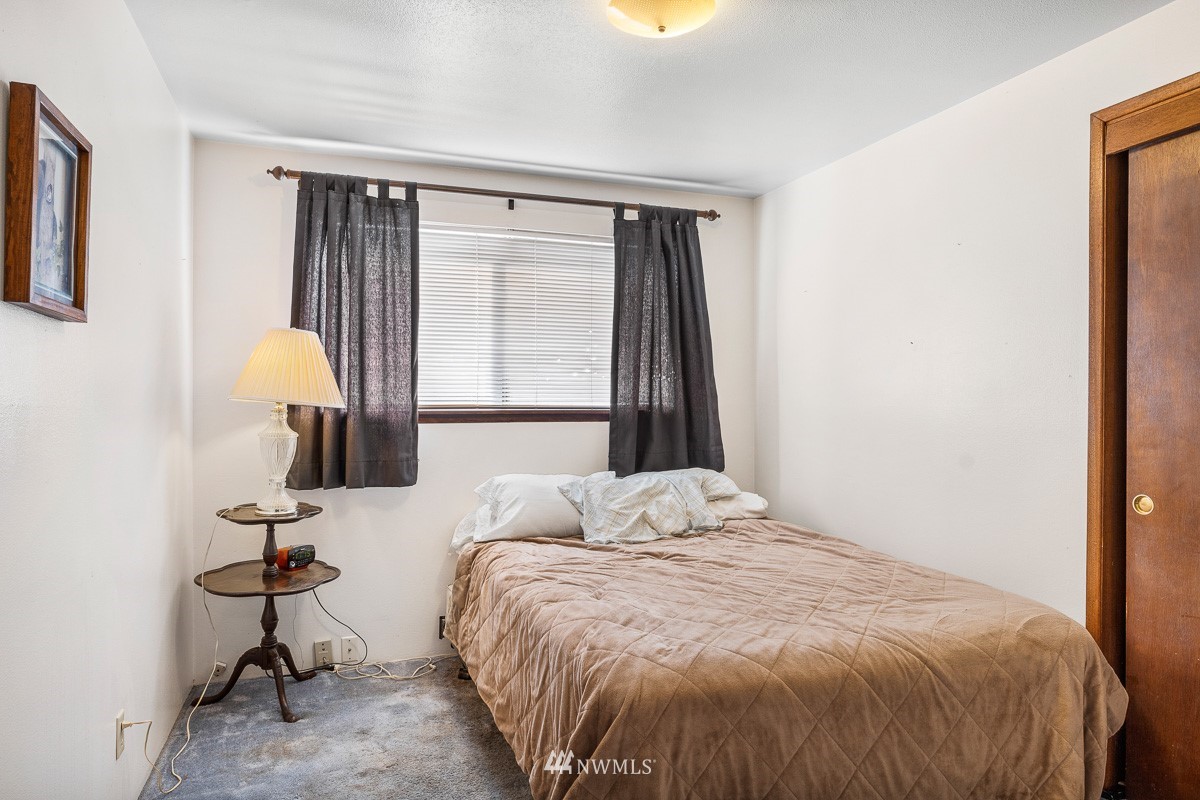 15053 Southeast 113th Street Renton, WA 98059 - Photo 22 of 31 a bedroom with a bed and a window