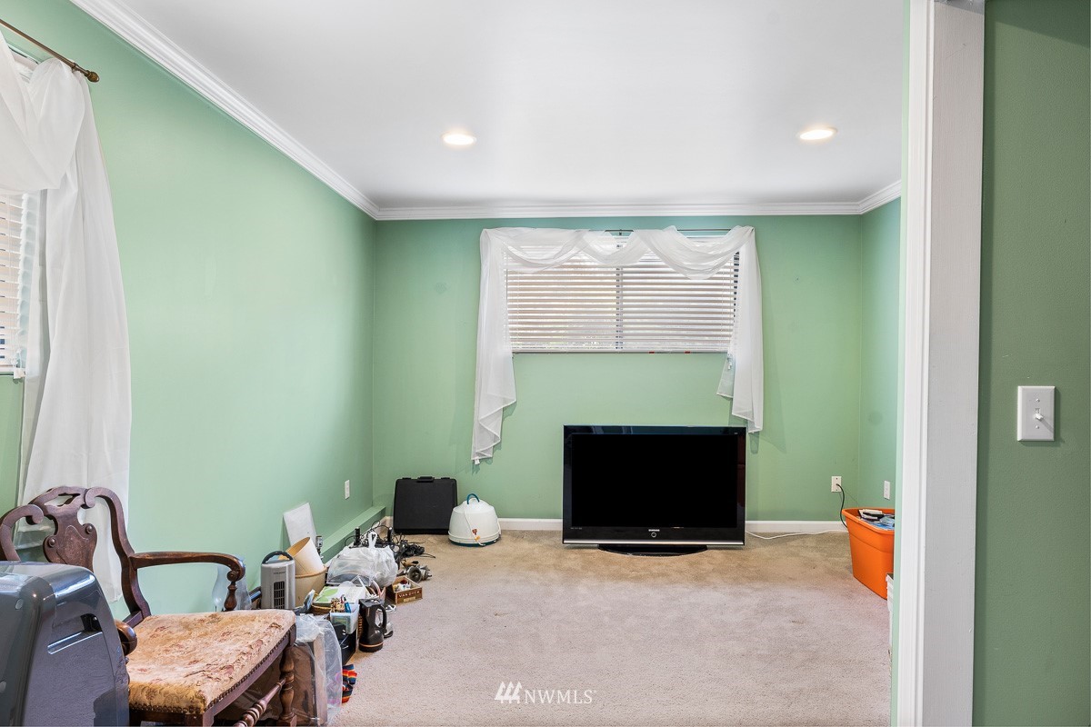 15053 Southeast 113th Street Renton, WA 98059 - Photo 24 of 31 a living room with furniture a fireplace and a flat screen tv
