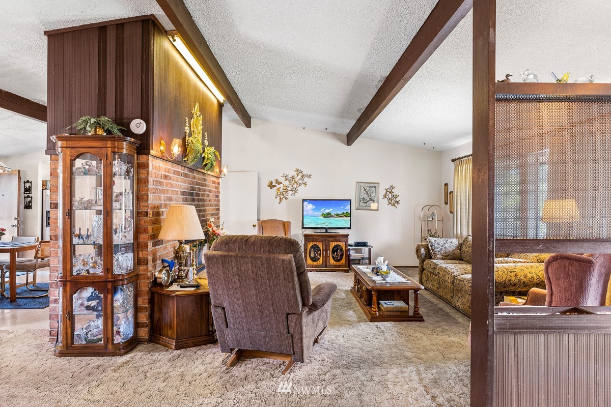 15053 Southeast 113th Street Renton, WA 98059 - Photo 5 of 31 a living room with furniture a window and a flat screen tv