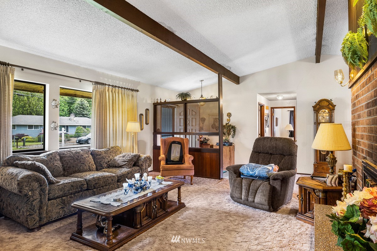 15053 Southeast 113th Street Renton, WA 98059 - Photo 7 of 31 a living room with furniture and a window