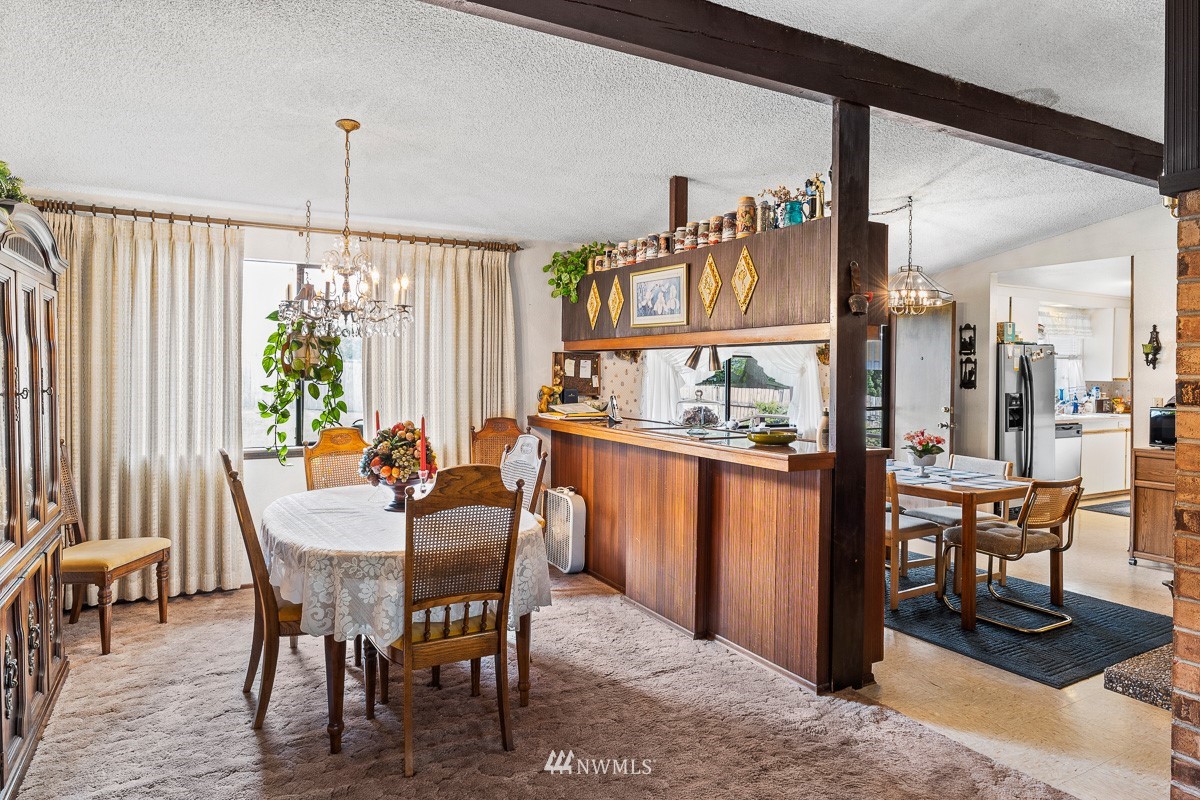 15053 Southeast 113th Street Renton, WA 98059 - Photo 10 of 31 a view of a dining room with furniture window and wooden floor