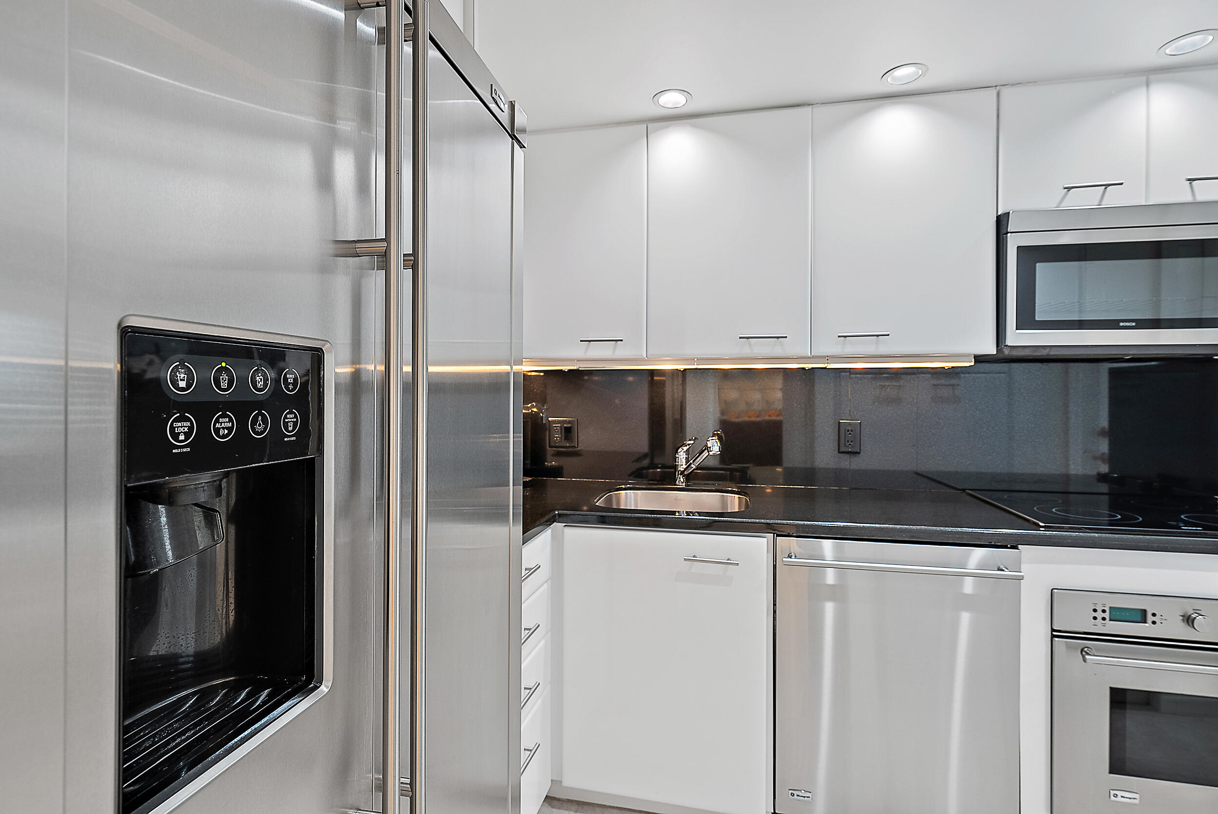 2780 South Ocean Boulevard, Unit 707 Palm Beach, FL 33480 - Photo 11 of 33 a kitchen with stainless steel appliances granite countertop a refrigerator and a stove