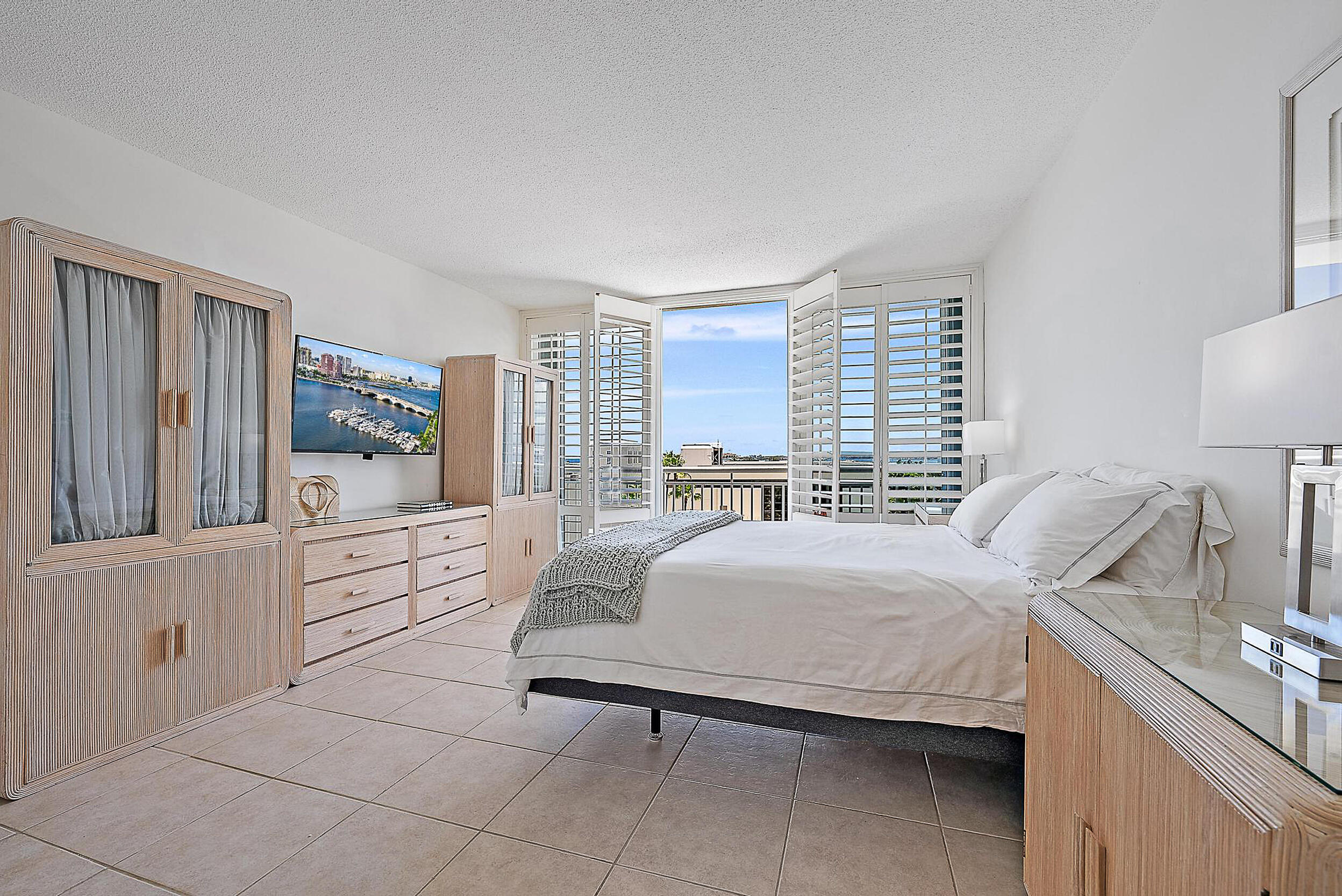 2780 South Ocean Boulevard, Unit 707 Palm Beach, FL 33480 - Photo 12 of 33 a bedroom with a bed and a large window