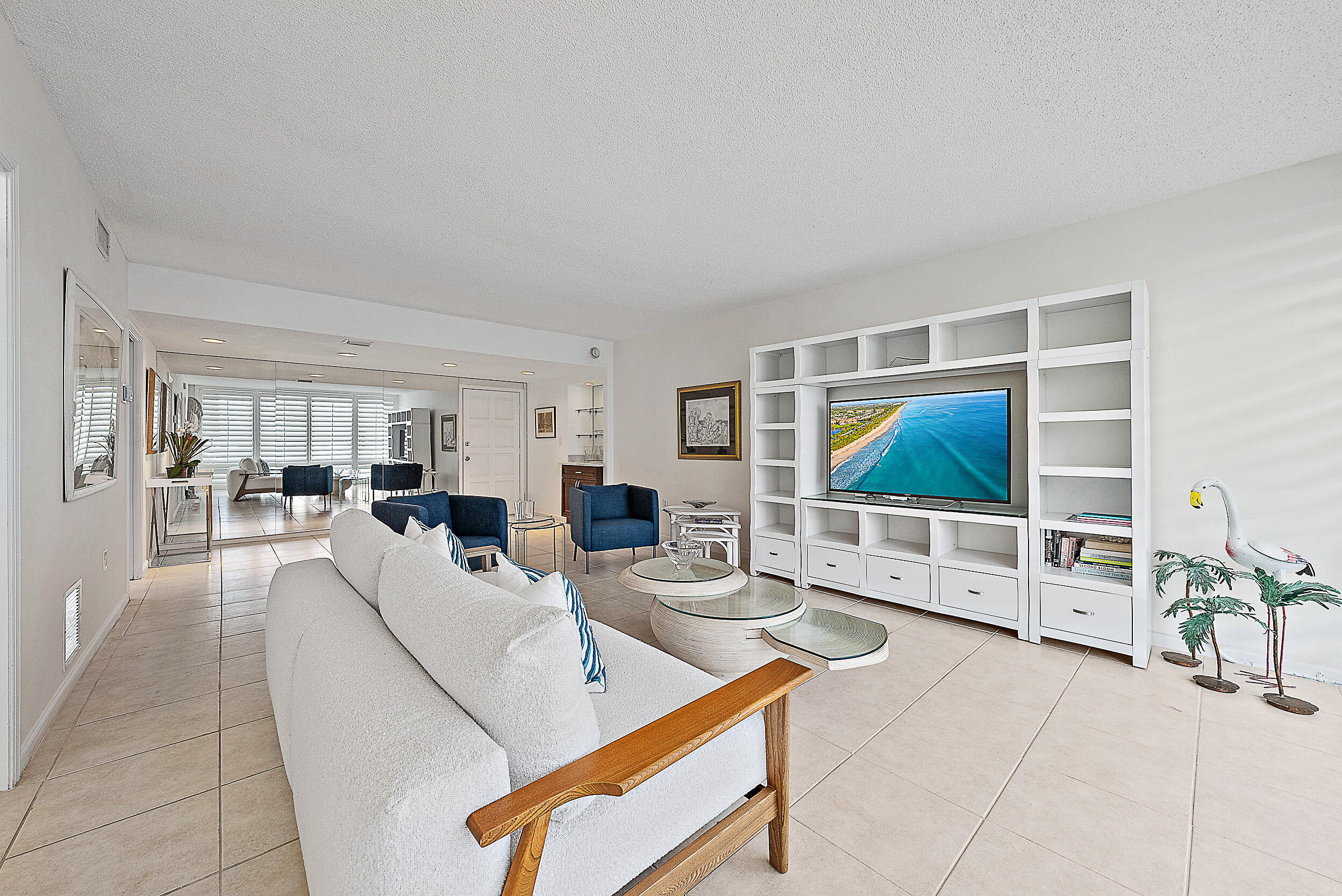 2780 South Ocean Boulevard, Unit 707 Palm Beach, FL 33480 - Photo 6 of 33 a living room with furniture and a flat screen tv