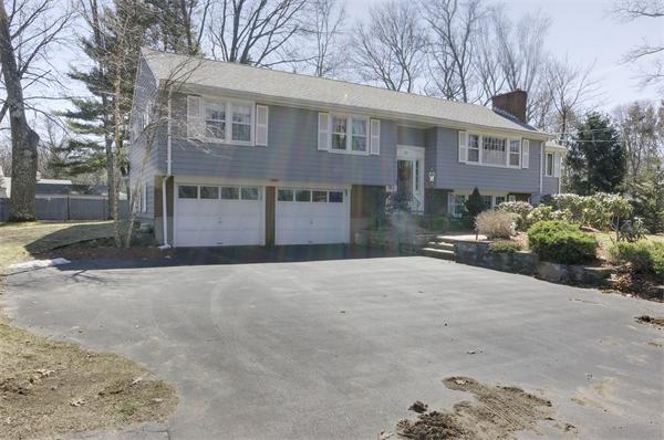 10 Phinney Road Lexington, MA 02421 - Photo 2 of 30 a front view of a house with a yard and garage