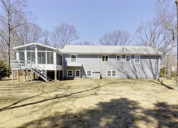 10 Phinney Road Lexington, MA 02421 - Photo 30 of 30 a big house with large trees and wooden fence