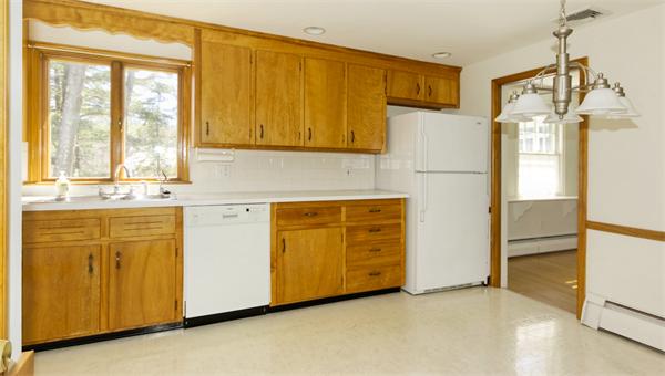 10 Phinney Road Lexington, MA 02421 - Photo 10 of 30 a kitchen with granite countertop white cabinets and white appliances
