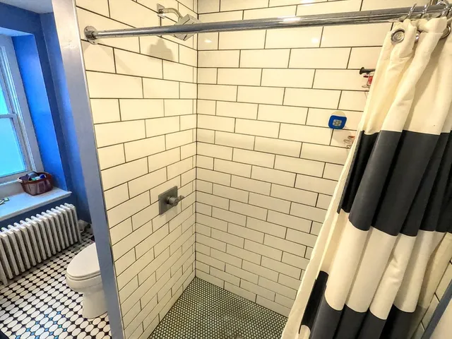 a bathroom with a shower and a sink