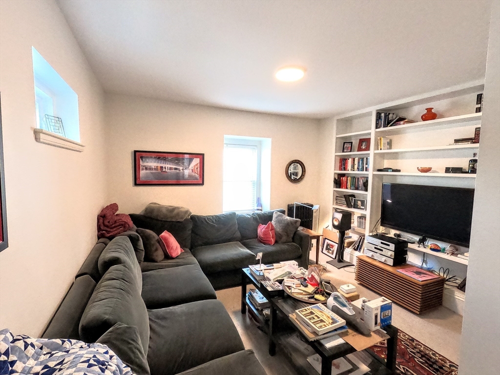 41 School Street, Unit 2 Boston, MA 02119 - Photo 15 of 36 a living room with furniture and a flat screen tv
