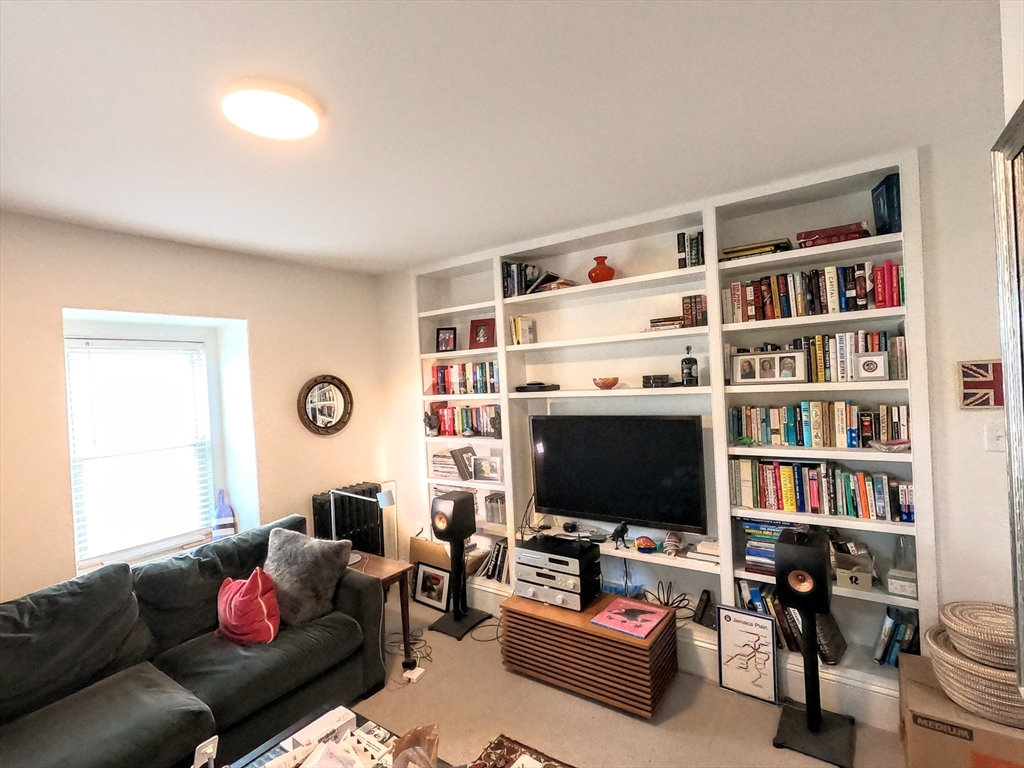41 School Street, Unit 2 Boston, MA 02119 - Photo 17 of 36 a living room with furniture workspace and a flat screen tv