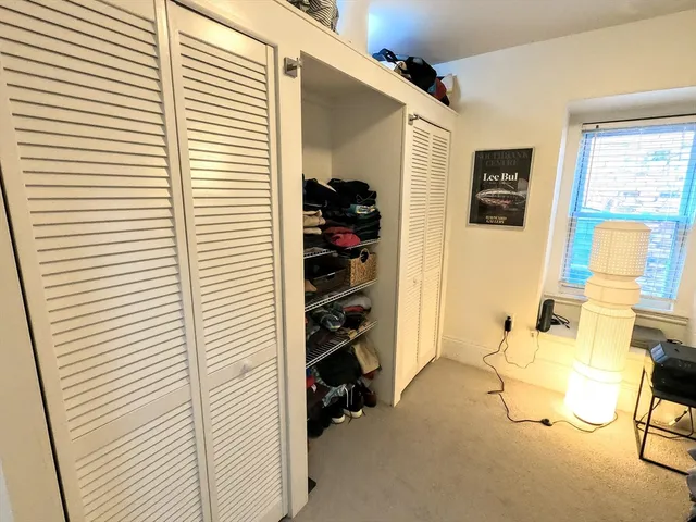 a view of a livingroom with lounge chair and a window