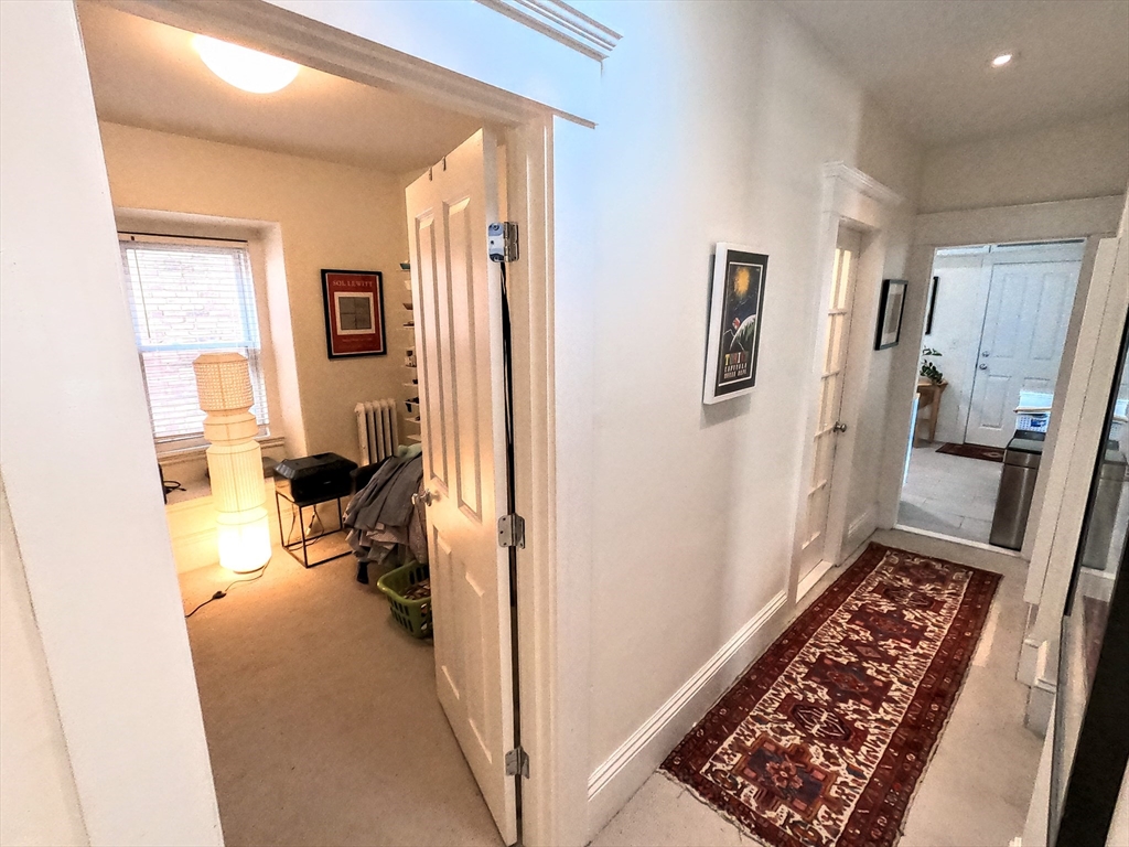 41 School Street, Unit 2 Boston, MA 02119 - Photo 23 of 36 a view of a hallway with living room and a couch