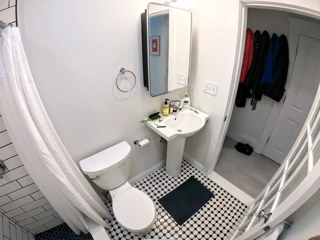 a bathroom with a sink toilet and mirror