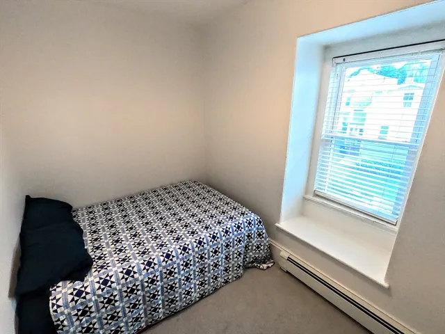 a bedroom with a bed and a mirror