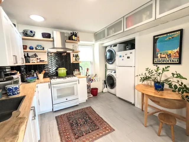 a kitchen with stainless steel appliances a stove a sink and a refrigerator