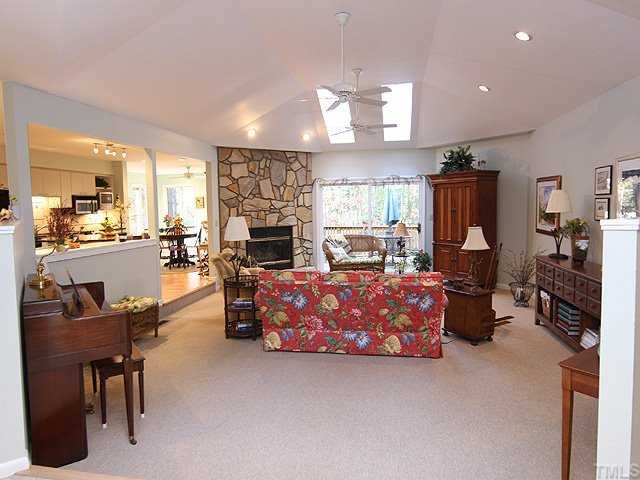 2800 Croix Place Raleigh, NC 27614 - Photo 2 of 12 Spacious family room featuring a vaulted ceiling with skylights and stone fireplace. Sliding doors open to deck and private wooded yard.Great for entertaining.