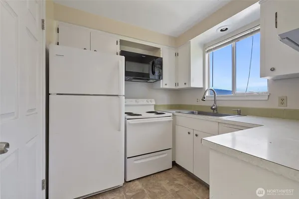 a white refrigerator freezer sitting in a kitchen